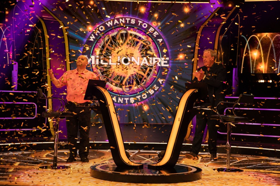 two men standing in front of a who wants to be a millionaire sign