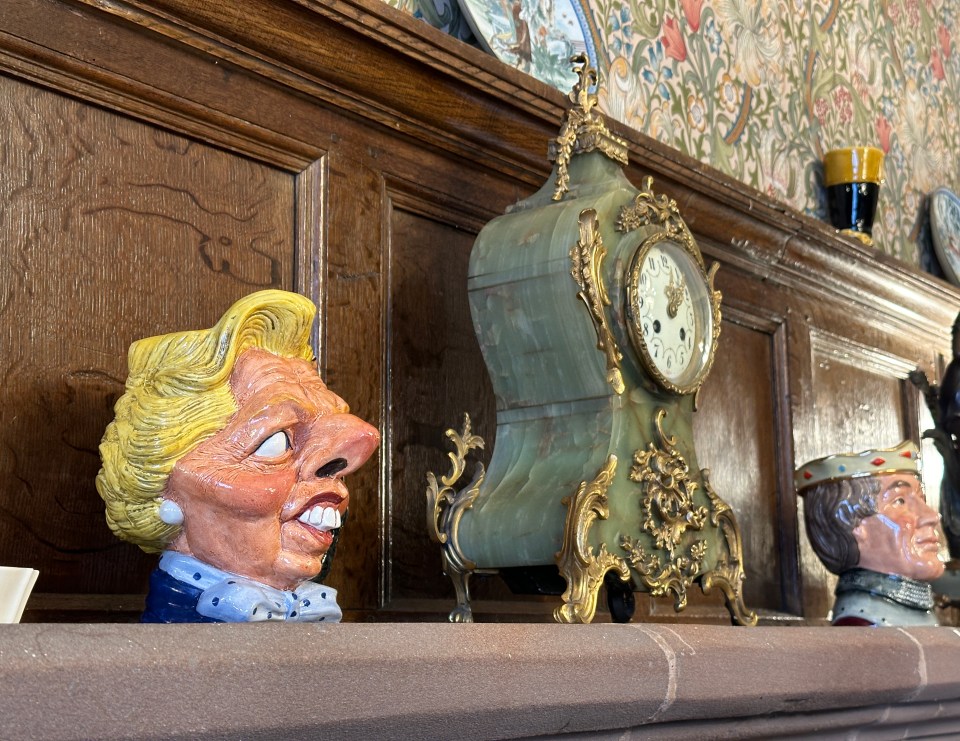 a mantle with a statue of a woman and a clock on it