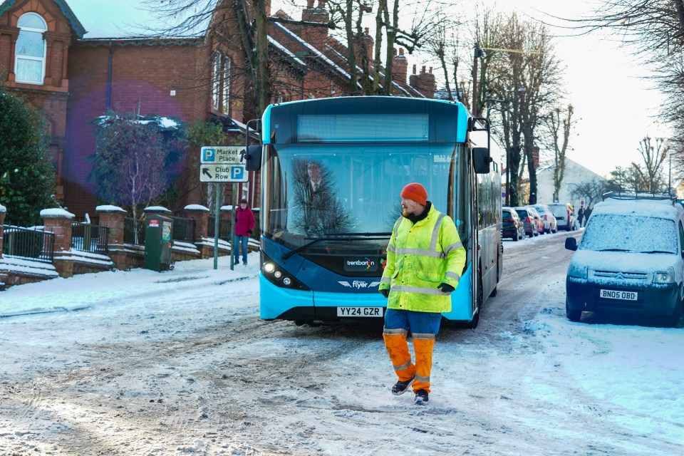 a man walking in front of a bus that says rye on the front