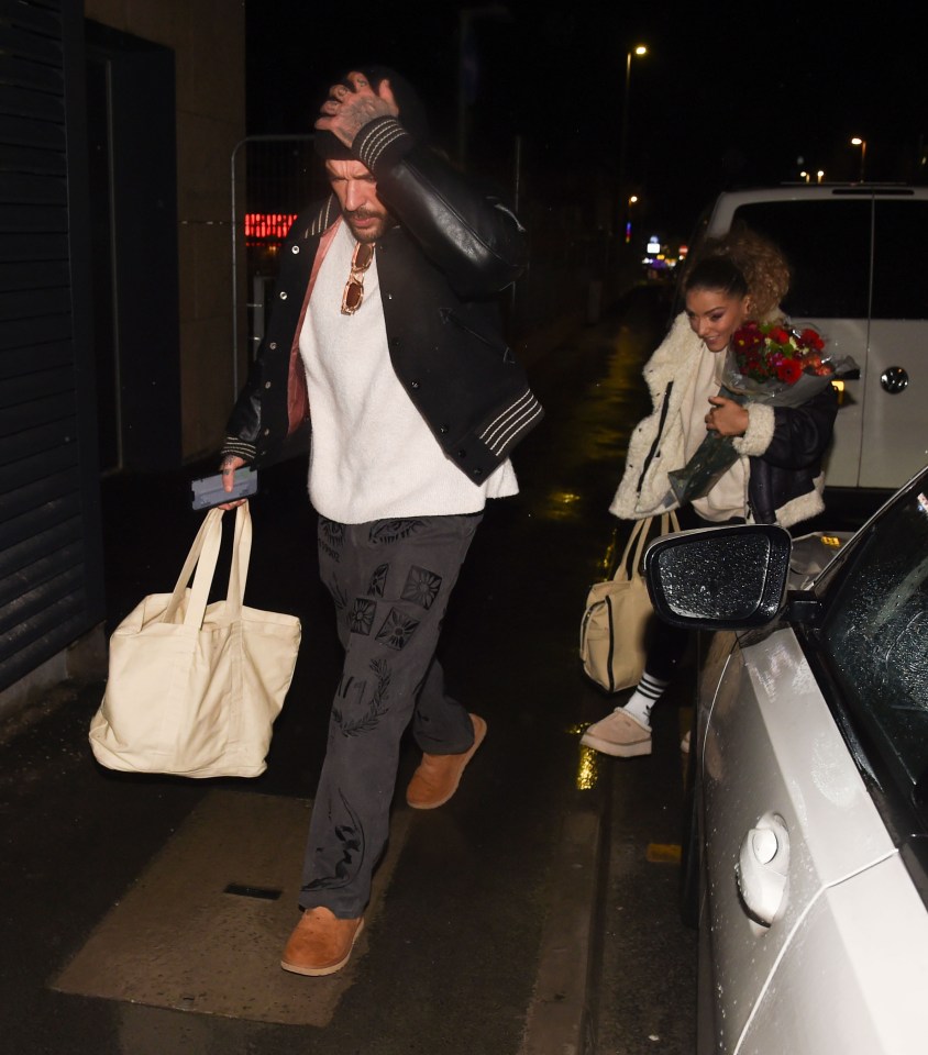 a man carrying a bag that says ' adidas ' on it