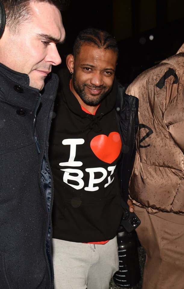 a man wearing a black shirt that says i love bpi