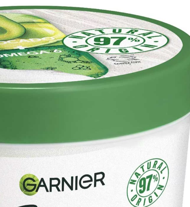 a green and white container of garnier natural origin