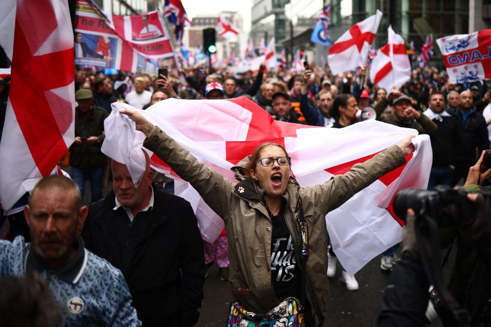 a woman holding a flag with the word britain on it