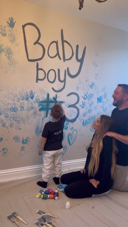 a baby boy # 3 is being painted on a wall