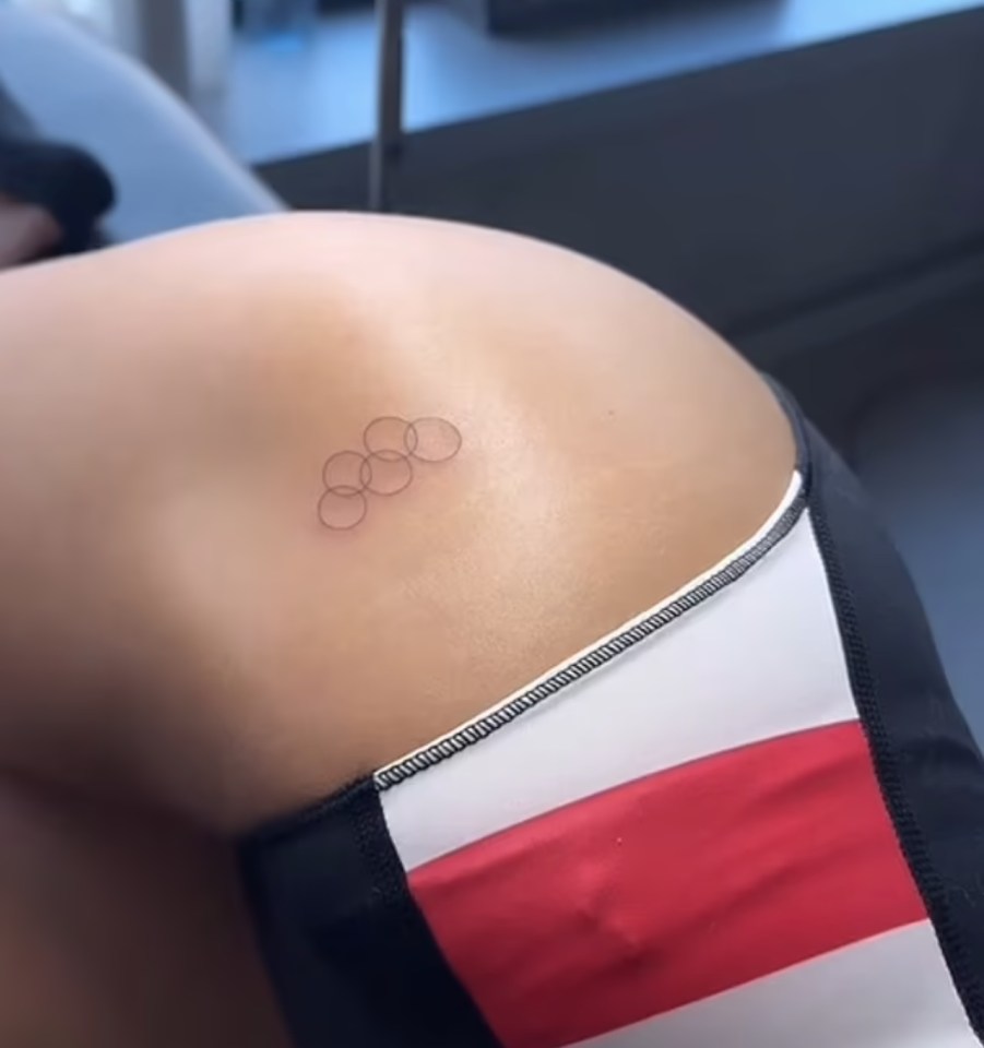 She got a tattoo of the Olympic rings on her thigh to mark the occasion