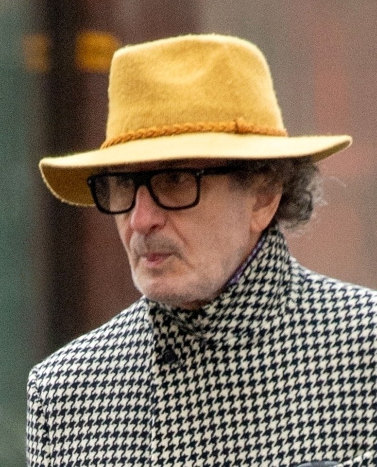 a man wearing glasses and a yellow hat