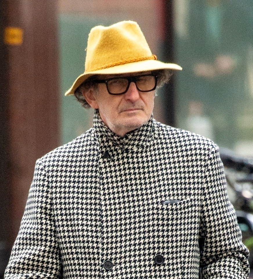 a man wearing glasses and a yellow hat