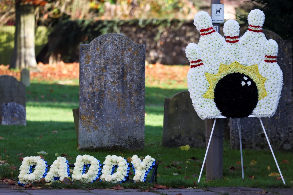 the word daddy is written in flowers in front of a bowling alley