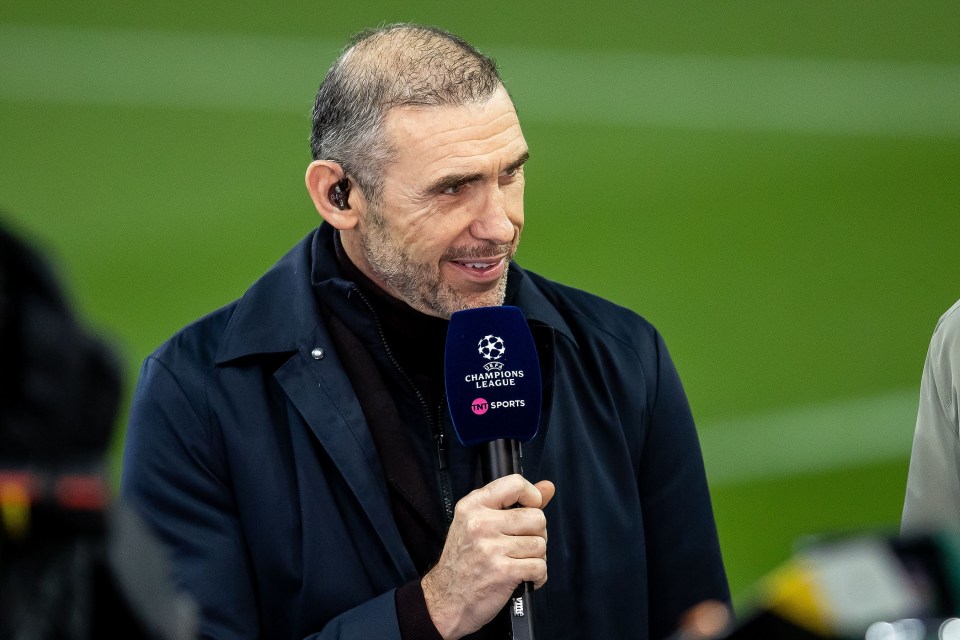 a man holding a microphone that says champions league on it