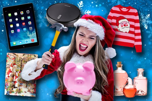 a woman in a santa hat is holding a hammer over a piggy bank