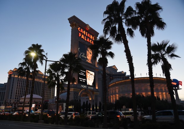 the caesars palace is lit up at night