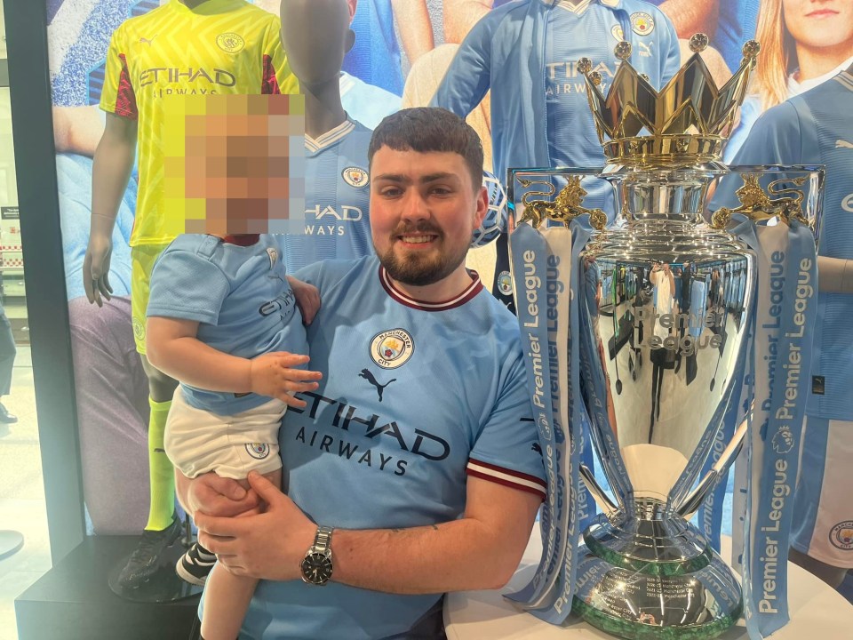 a man in an etihad airways shirt holds a baby