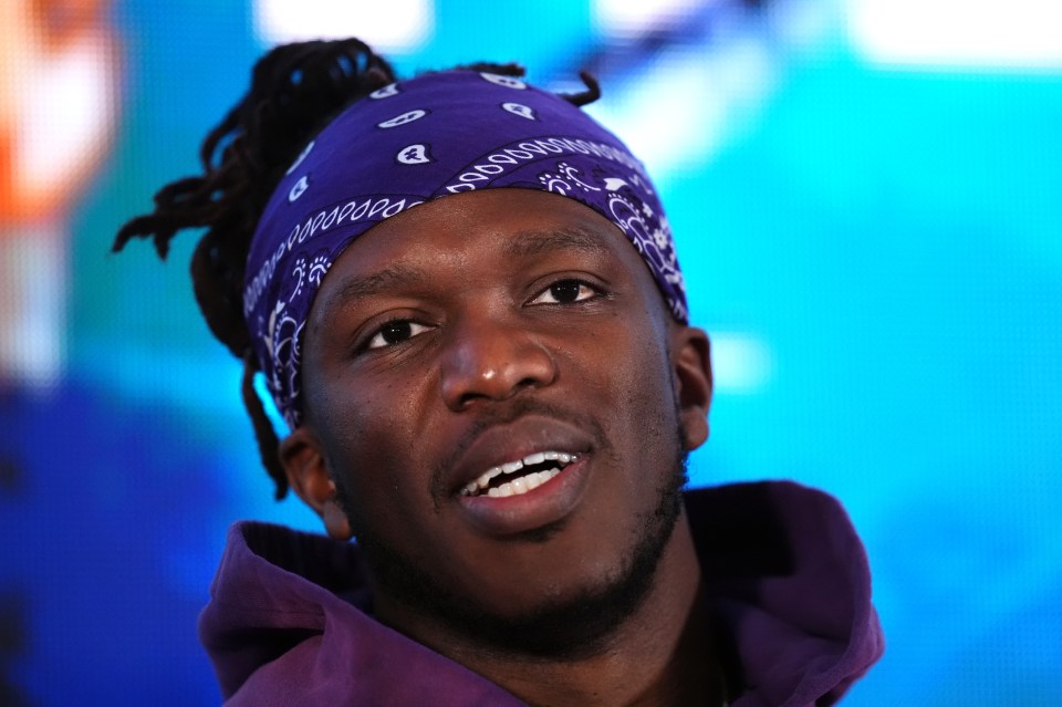 a close up of a man wearing a purple bandana