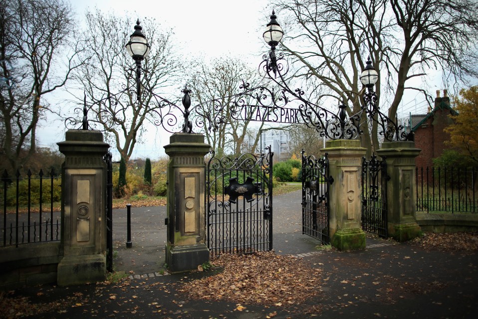 a wrought iron gate with the words plaza park on it