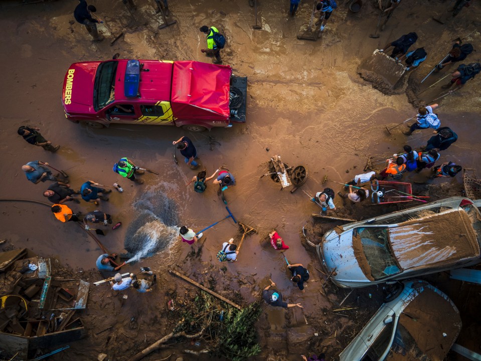 a red bombers truck is parked in the mud