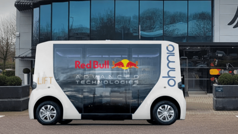 a red bull advanced technologies vehicle is parked in front of a building