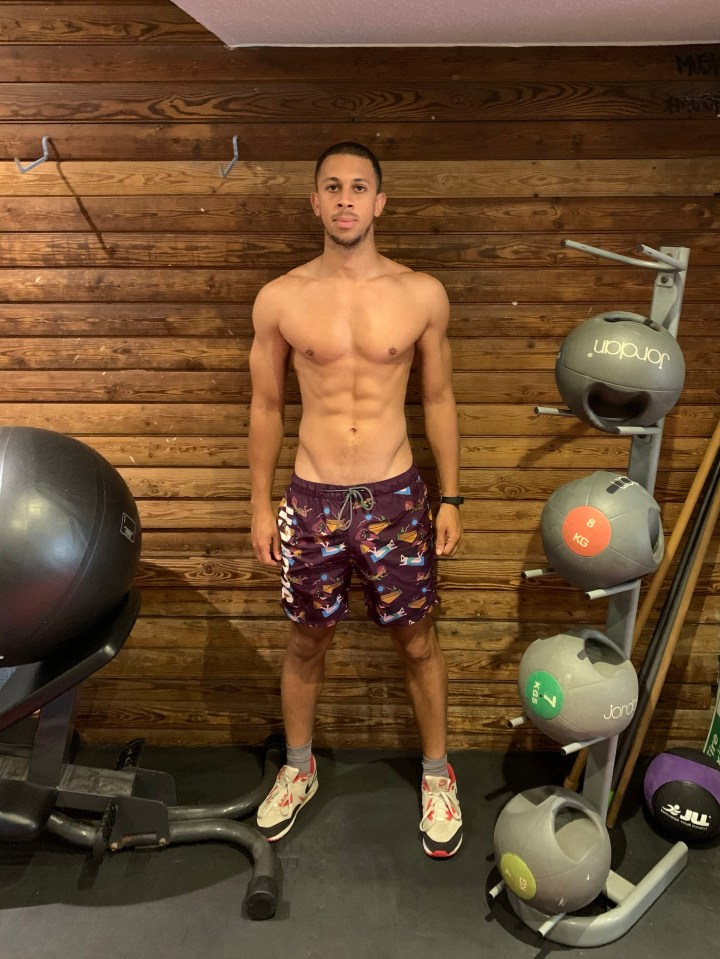 a man stands in front of a display of jordan medicine balls