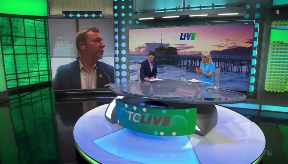 a man and a woman sit at a table in front of a screen that says tclive