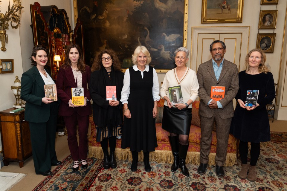 a group of people holding books including one that says obelisk