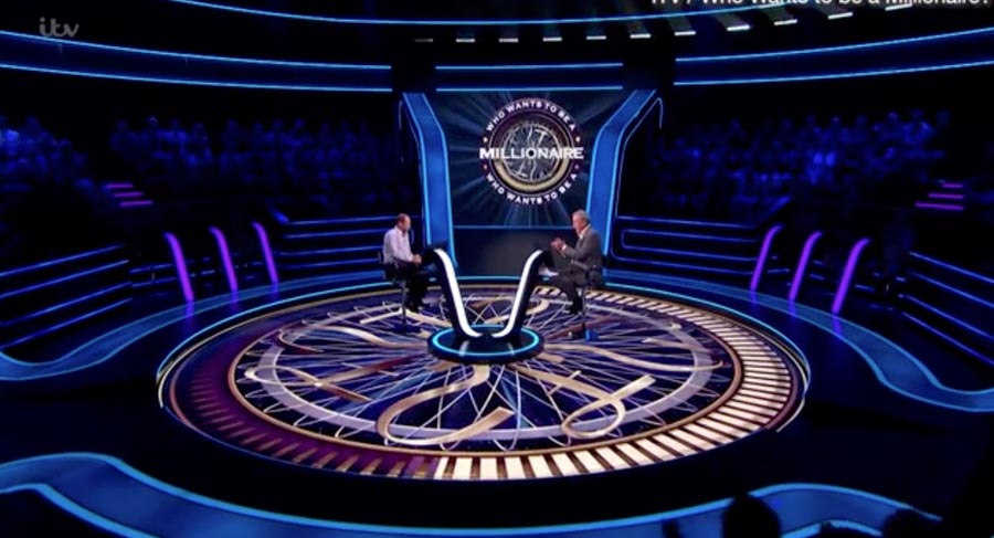 Who Wants to Be a Millionaire? set with contestant and host.