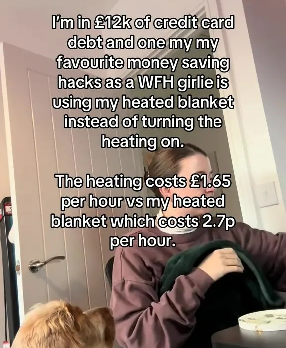 Woman uses heated blanket to save money on heating costs.