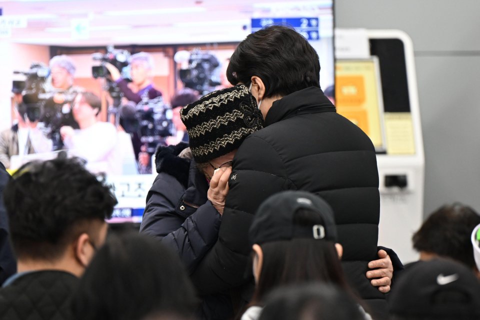 Relatives weep as they desperately wait for news on the passengers