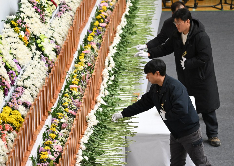 Mourners pay their respects at a memorial altar for victims of the Jeju Air plane crash