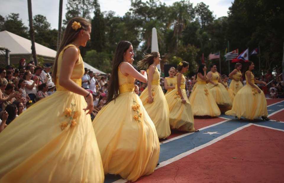 Performers walk in traditional outfits during the festivities