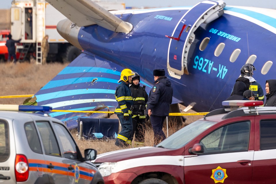 Emergency responders at the crash site of an Azerbaijan Airlines Embraer 190 passenger jet.