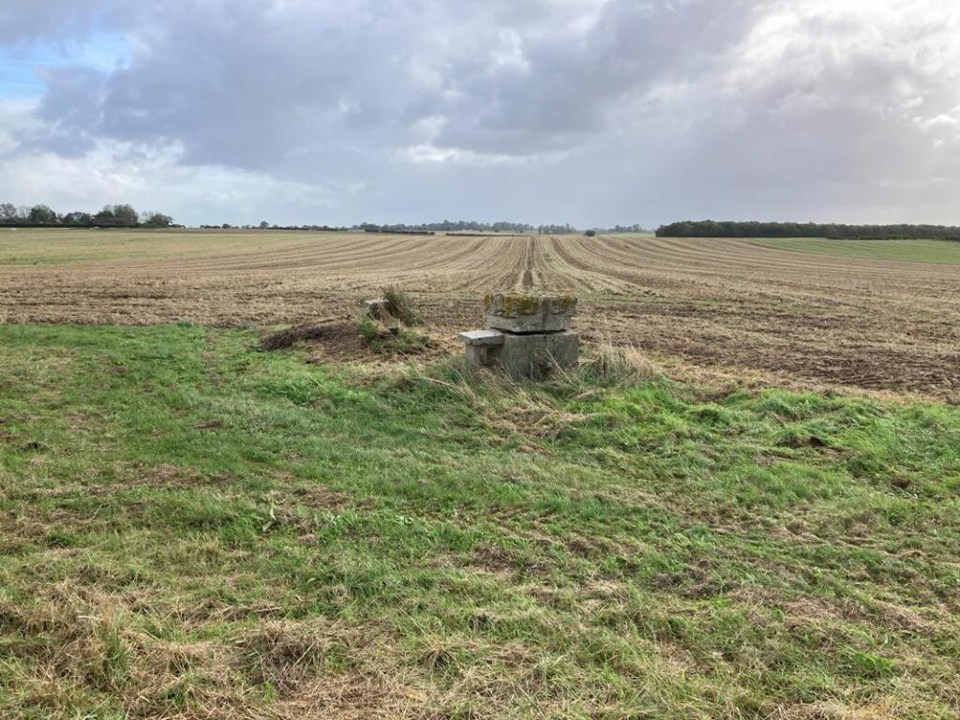 1950s underground bunker for sale in a field.