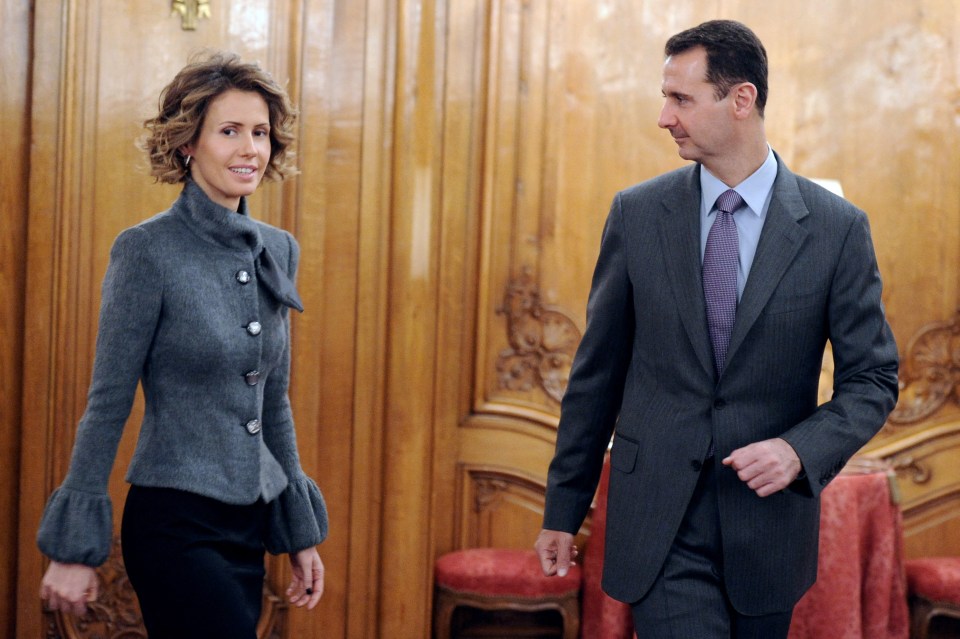 Syrian president Bashar al-Assad and his wife Asma arrive to deliver a speech for the Syrian Community