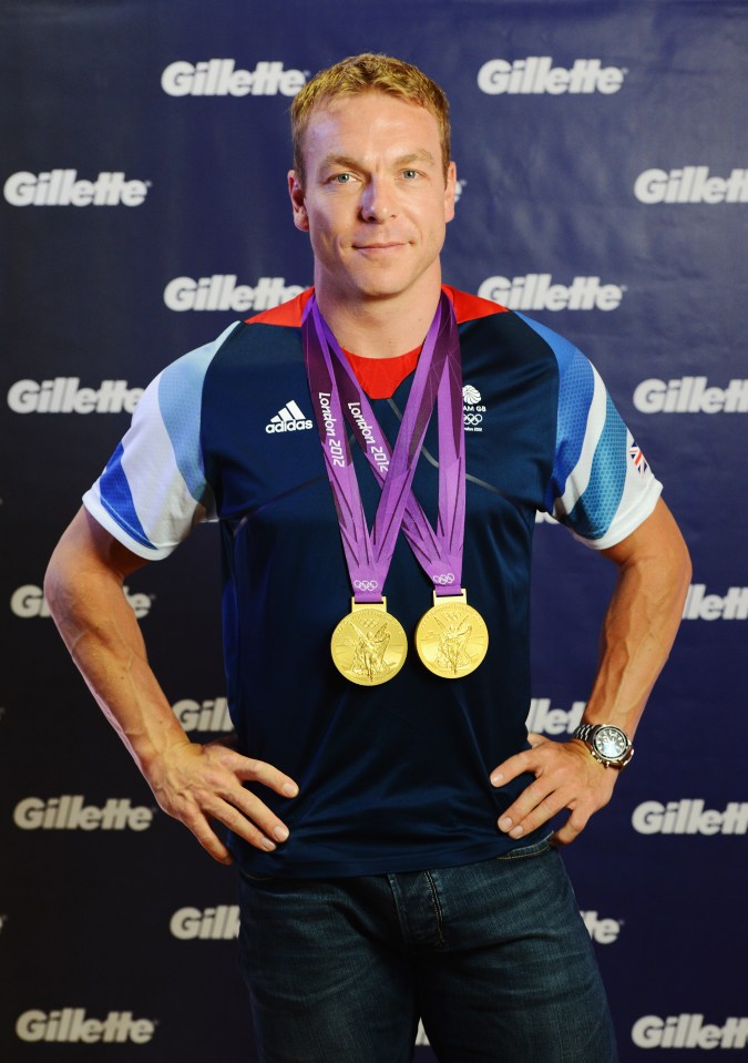 Sir Chris Hoy, wearing a Team GB cycling jersey and two gold medals.