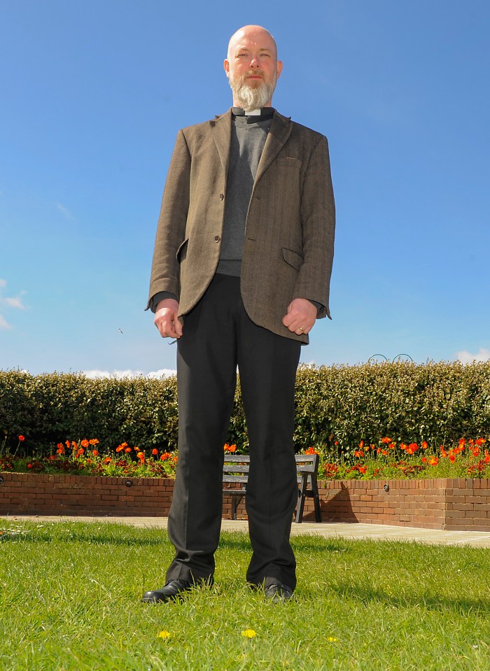 Vicar Rev Dr Paul Chamberlain standing outside.