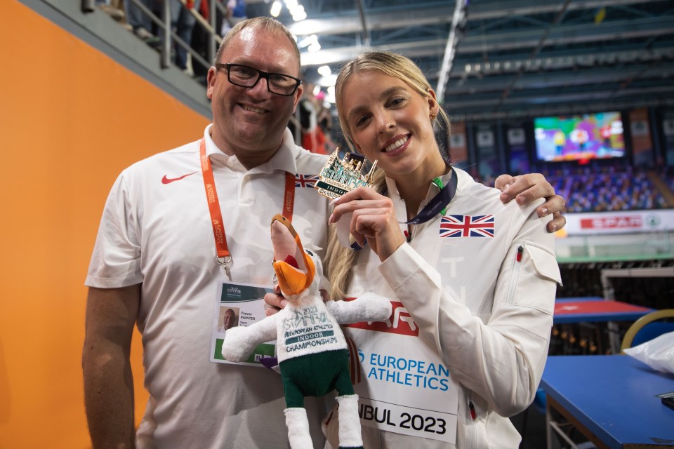 Keely Hodgkinson posing with  coach Trevor Painter after receiving the 800m gold medal at the 2023 European Indoor Championships in  in Istanbul, Turkey