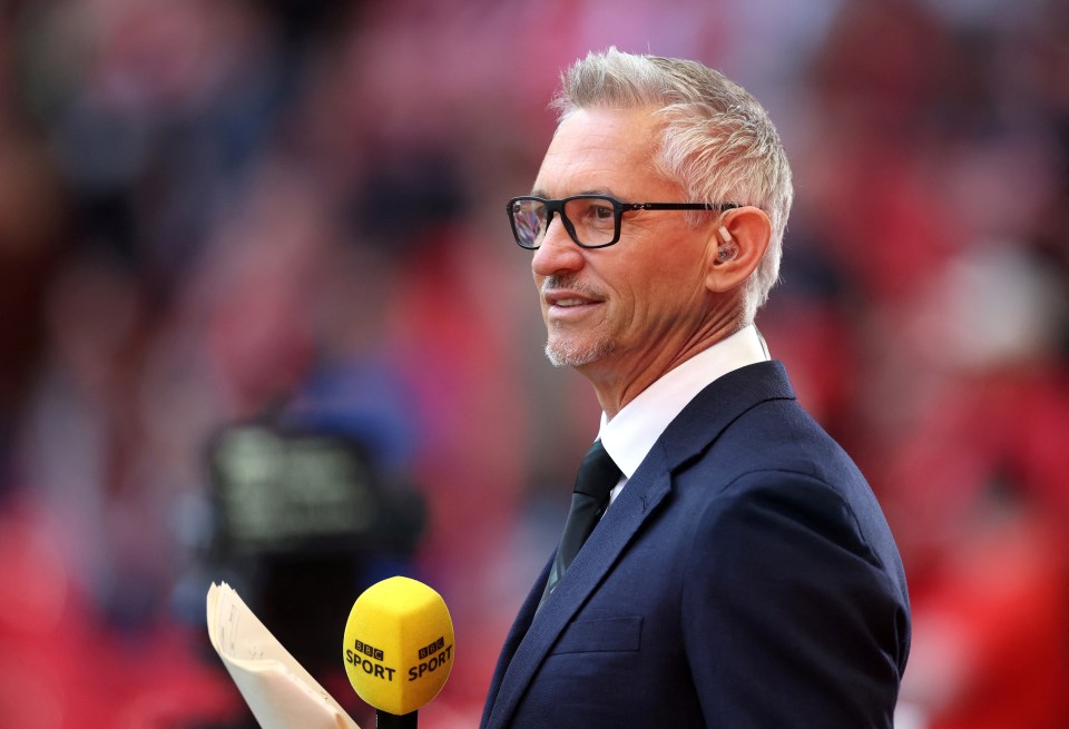 Gary Lineker at a soccer match, holding a BBC Sport microphone.