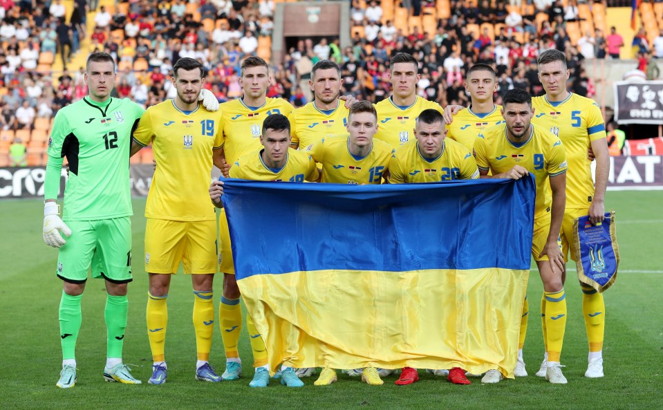 Ukrainian soccer team posing with their flag.