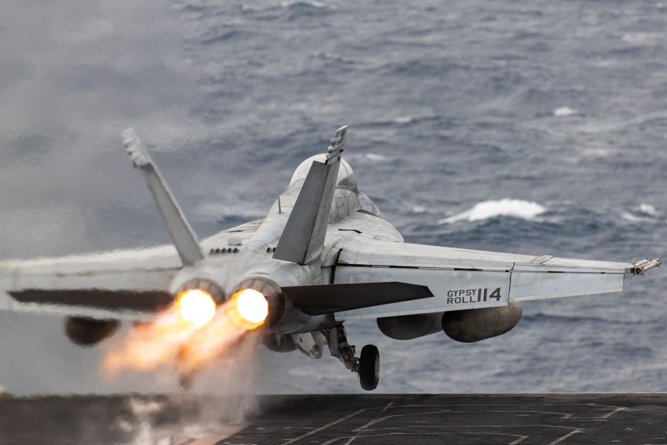 An F/A-18 Super Hornet fighter jet takes off from the flight deck of the USS Dwight D. Eisenhower