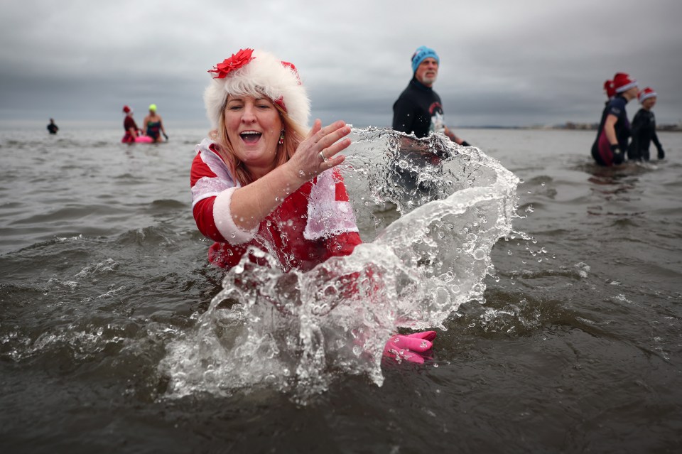 Woman in Santa suit participating in a charity swim.