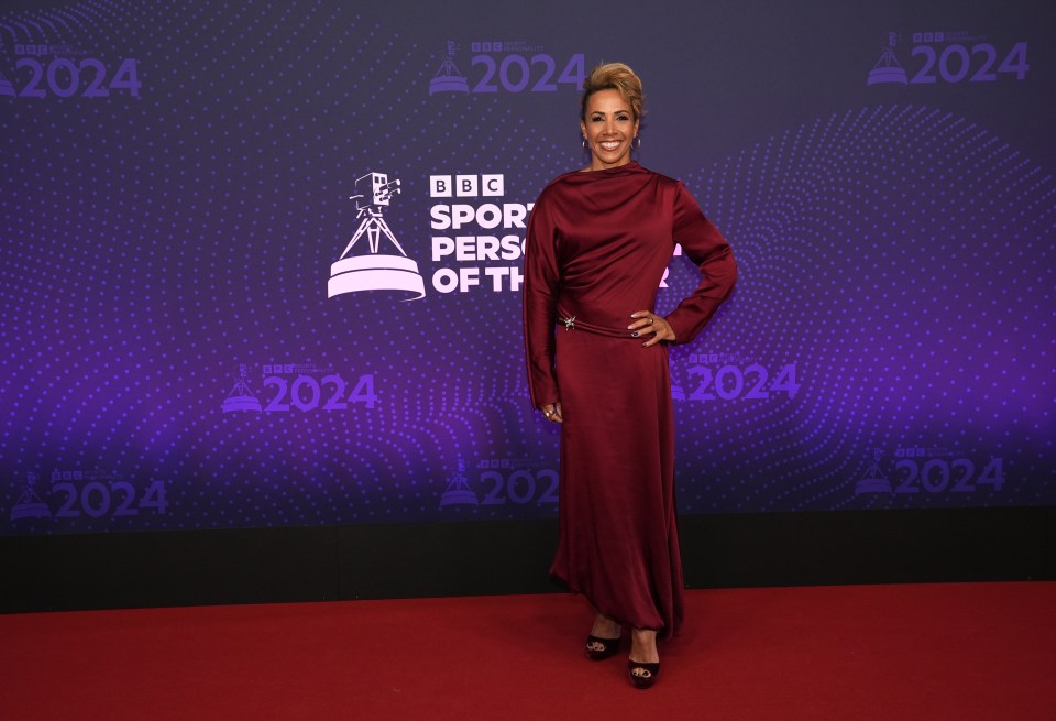 Dame Kelly Holmes smiles on the red carpet