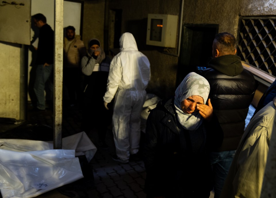 People searching for missing family members queue to see bodies