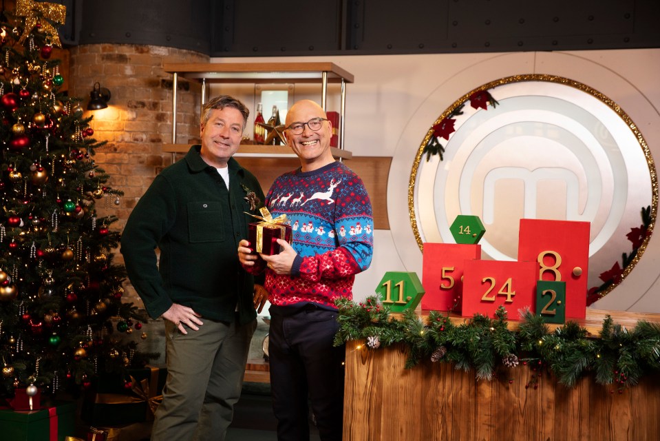 Wallace poses in a Christmas jumper alongside co-host John Torode