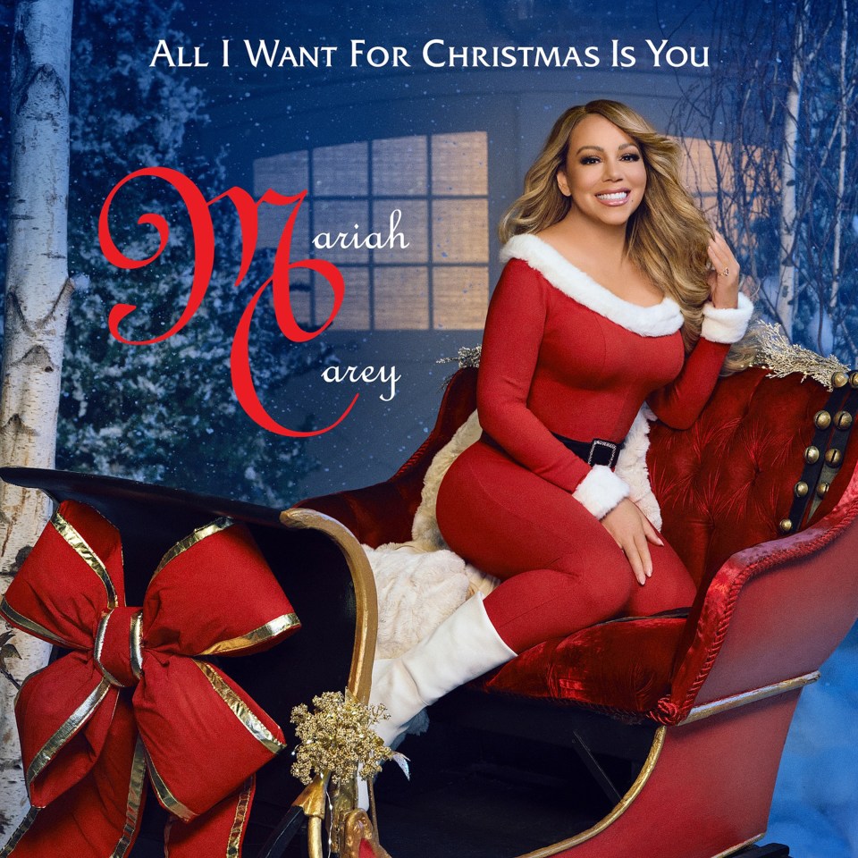 Mariah Carey in a Santa Claus outfit sitting in a sleigh, promoting her "All I Want For Christmas Is You" album's 12" LP and CD single releases.