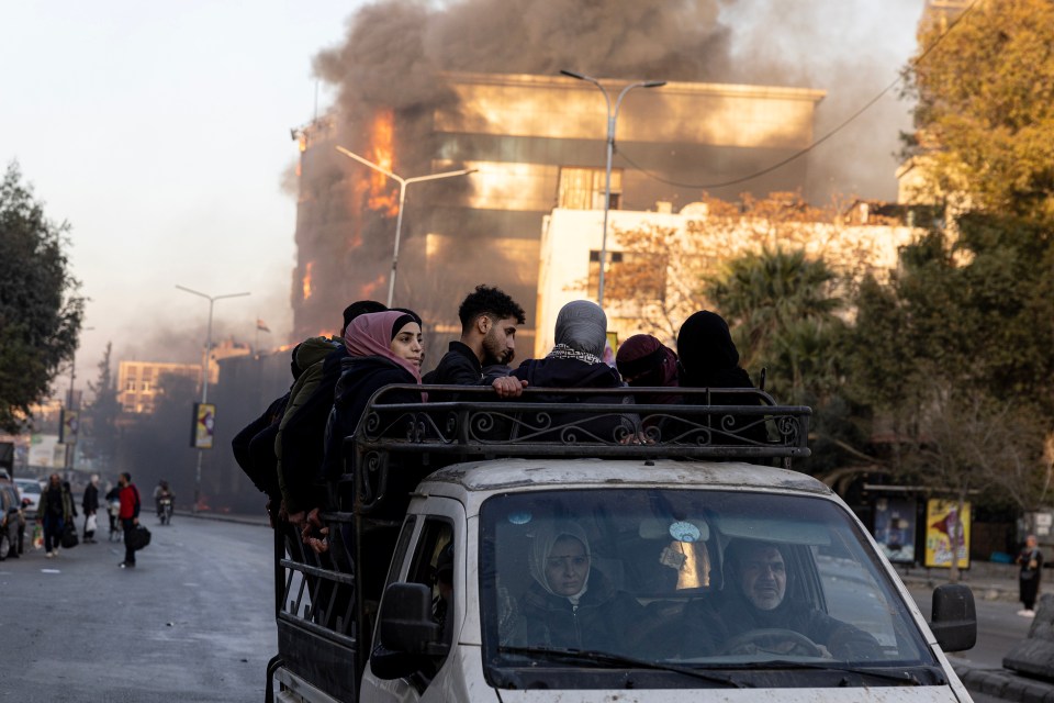 Civilians celebrate in Damascus on Sunday after Assad flees