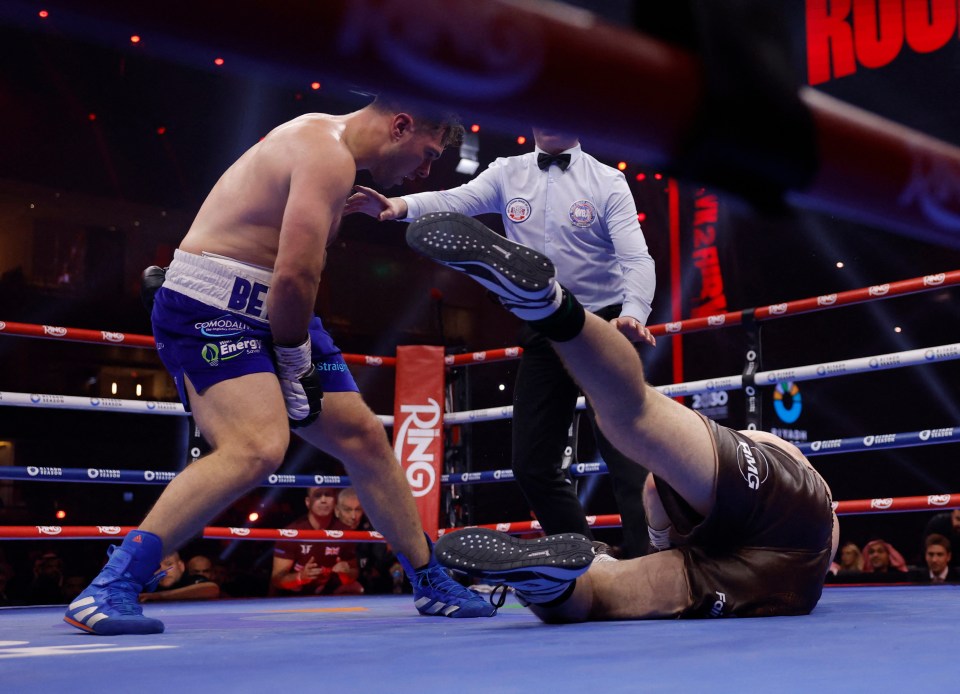 Dave Allen knocks down Johnny Fisher in a boxing match.