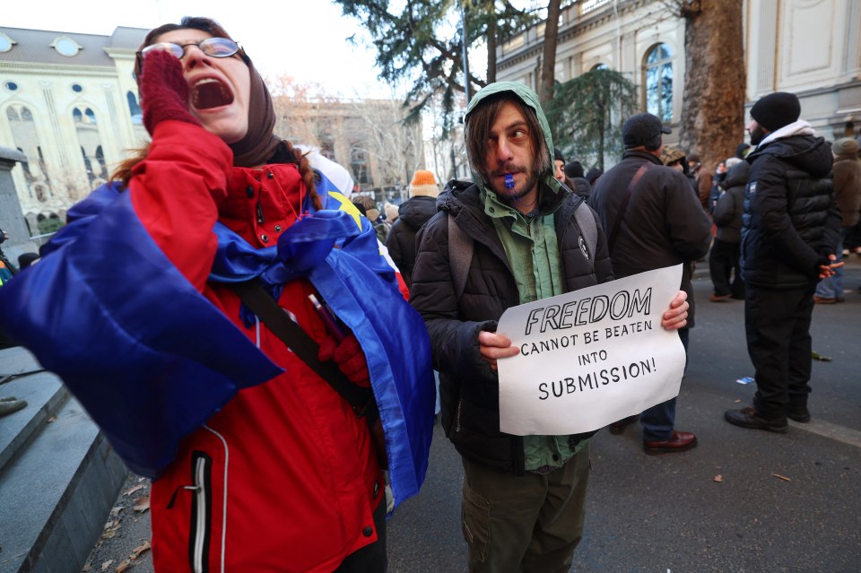 Protestors demonstrate outside the Georgian parliament building against the election of a new president.