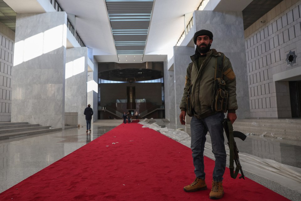 A rebel fighter inside the presidential palace