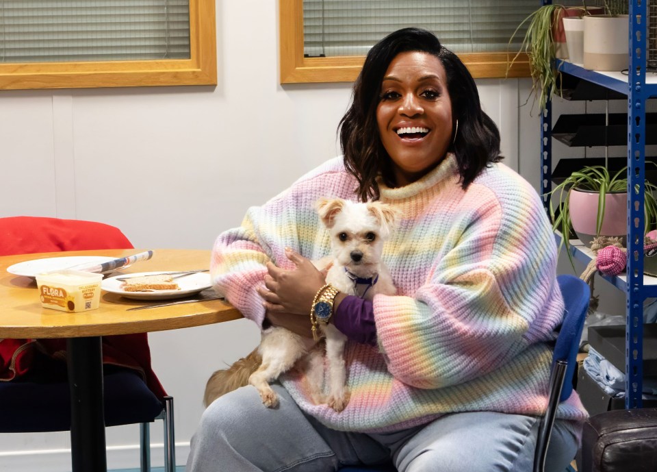 Alison Hammond holding a small dog.