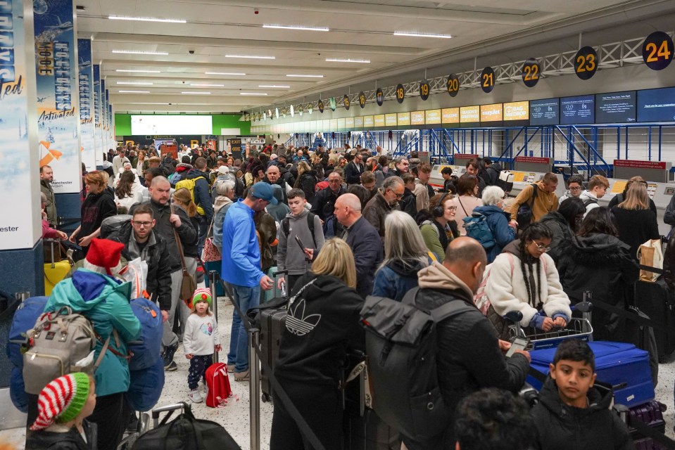 Festive passengers queuing for check-in at Manchester Airport