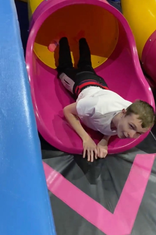 Mason Rist, 15, on a playground slide.