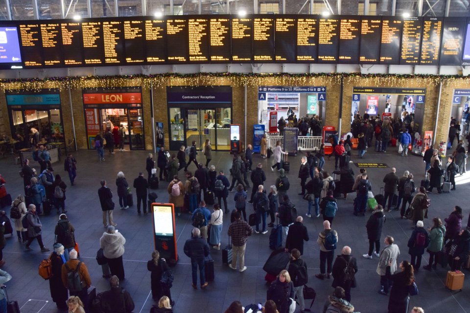 Passengers wait for trains at King's Cross Station